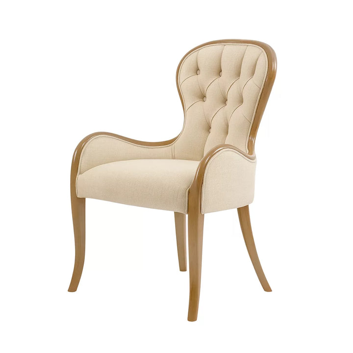 Bej renkli döşemeye sahip, ahşap ayaklı avangart tasarım kapitoneli yemek sandalyesi.