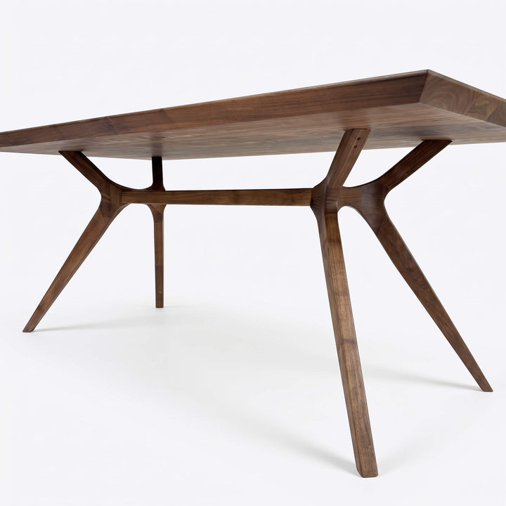 Minimalist solid walnut dining table featuring smooth wooden surface and stylish armchairs   